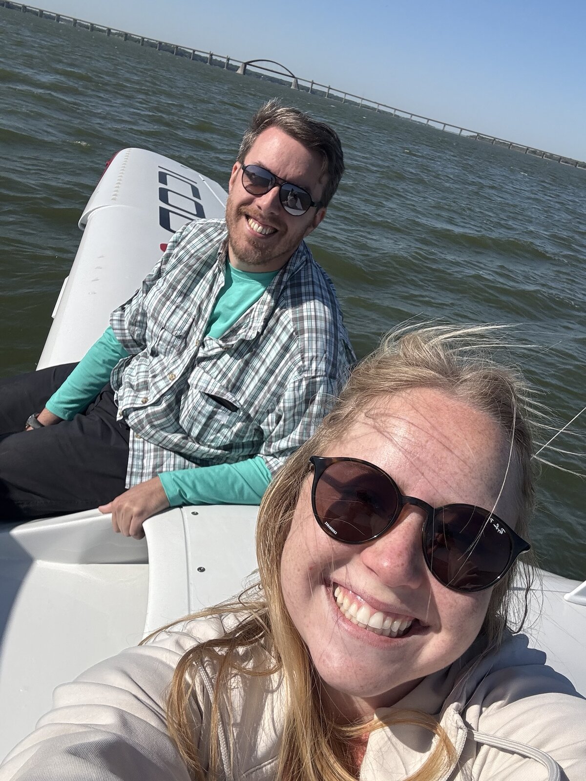 Josh and Maddie sitting on the wing of the ICON A5 in the middle of a lake